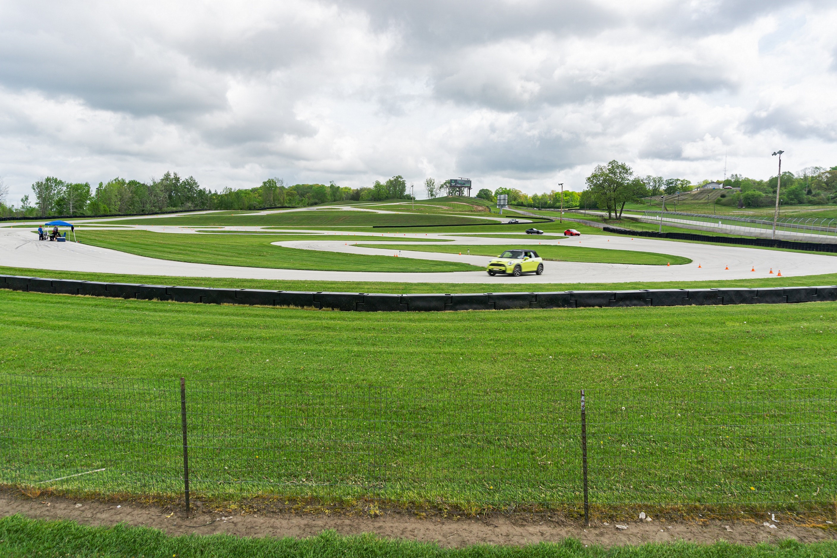 A 2022 Mini Cooper S Convertible, Toyota GR86 and Mazda MX-5 Miata RF racing through an autocross course at the Road America go-kart track