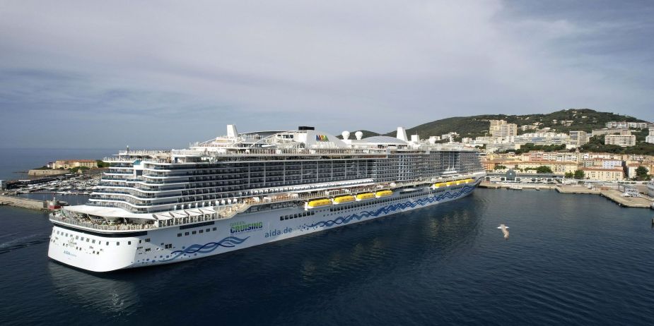 A large cruise ship sails on the water. 