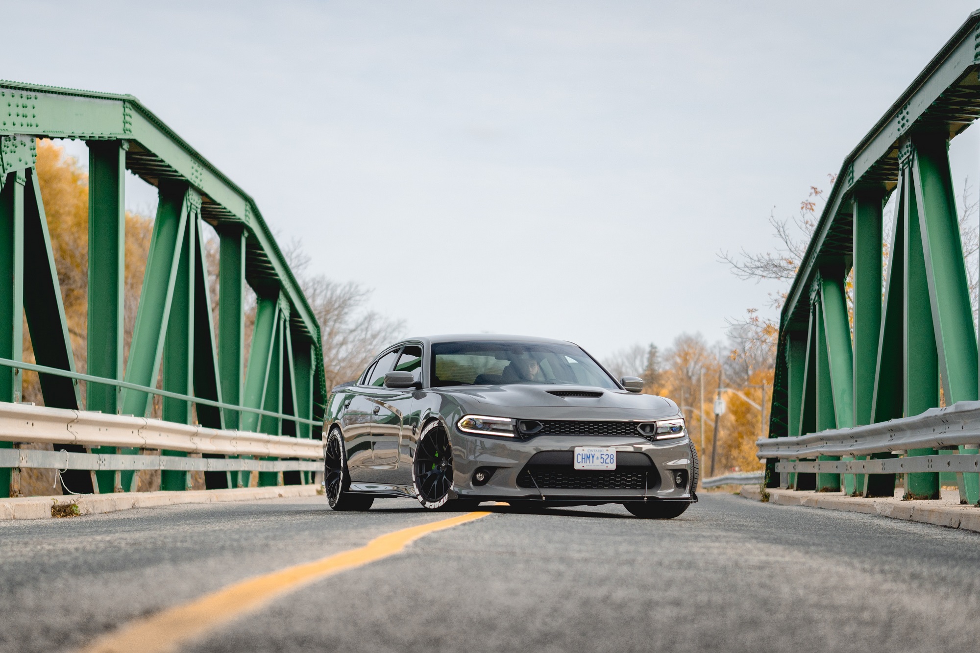 A Dodge Charger poses on a bridge