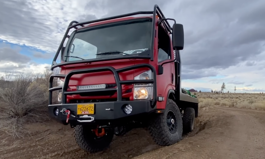 A red EarthCruiser CORE driving off-road