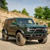 A green 2022 Ford Bronco, potentially with the Sasquatch package, parked outdoors.