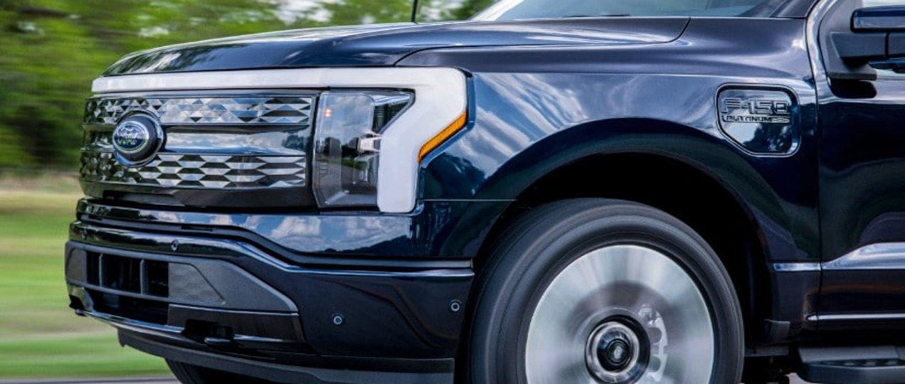 The front of a black 2022 Ford F-150 Lightning Platinum electric pickup truck.