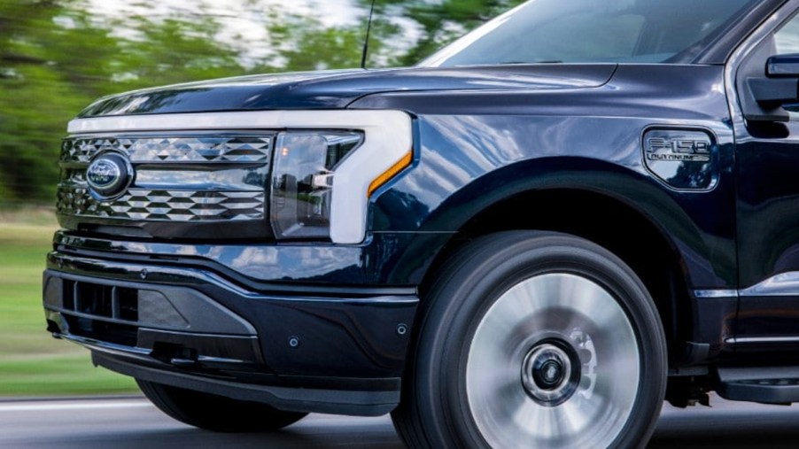 The front of a black 2022 Ford F-150 Lightning Platinum electric pickup truck.