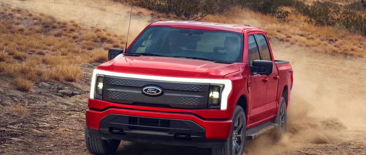 A red 2022 Ford F-150 Lightning electric pickup truck.