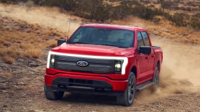 A red 2022 Ford F-150 Lightning electric pickup truck.