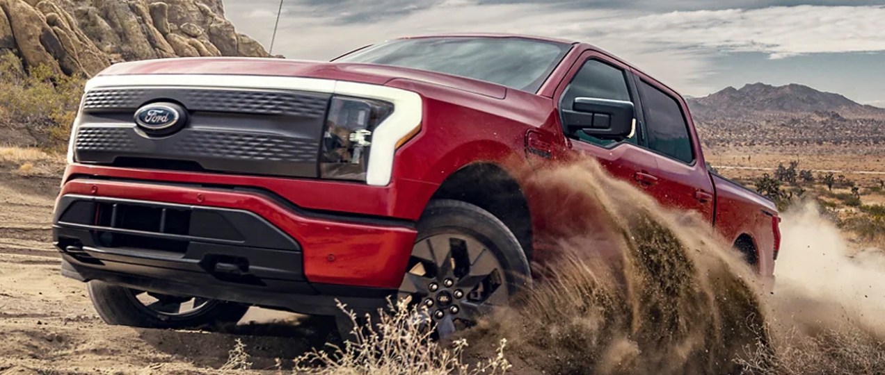 A red 2022 Ford F-150 Lightning electric pickup truck.