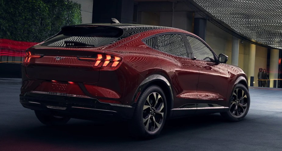A red 2022 Ford Mustang Mach-E electric SUV is parked. 