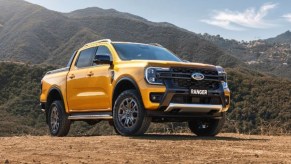 A yellow Ford Ranger Wildtrak small pickup truck is parked outdoors.