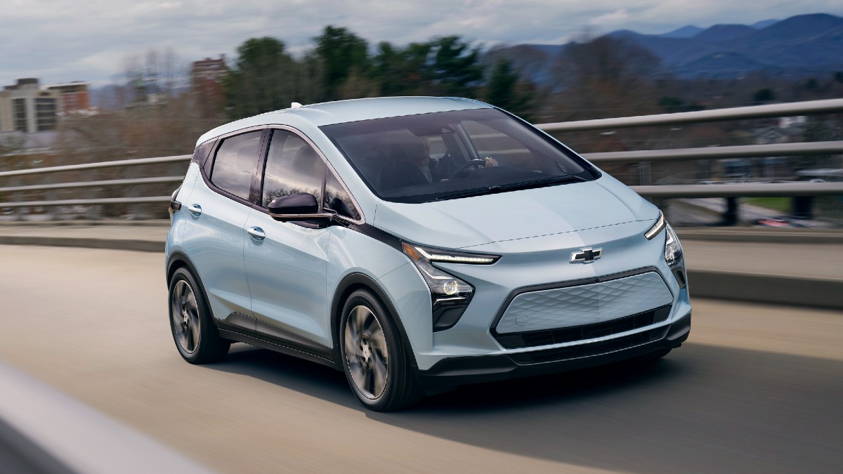 Front angle view of light blue 2023 Chevy Bolt EV, highlighting its release date and price