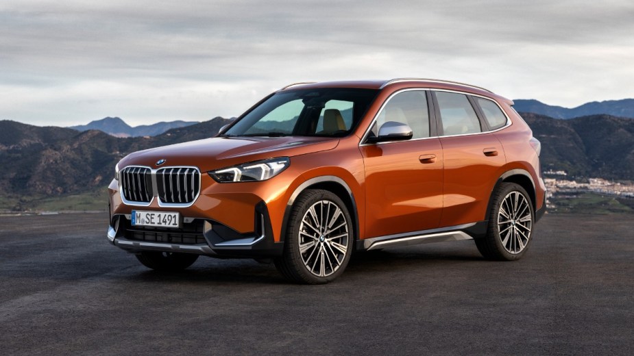 Front angle view of orange 2023 BMW X1, highlighting its release date and price