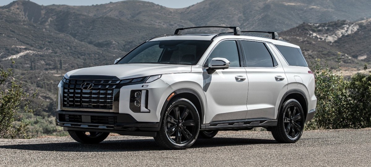 Front angle view of white 2023 Hyundai Palisade, highlighting its cost for each trim