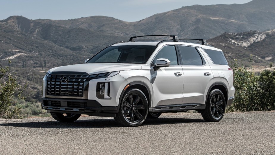 Front angle view of white 2023 Hyundai Palisade, highlighting its cost for each trim