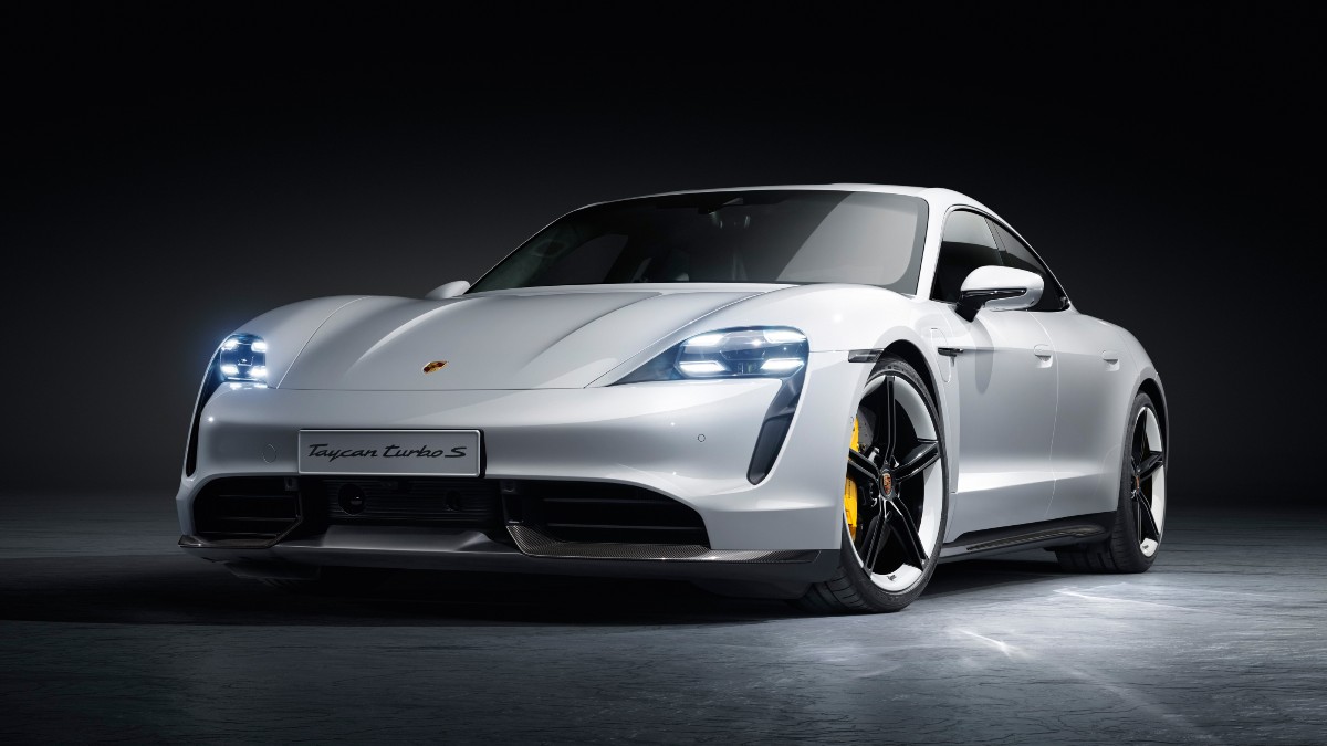 Front angle view of white 2023 Porsche Taycan, highlighting its release date and price