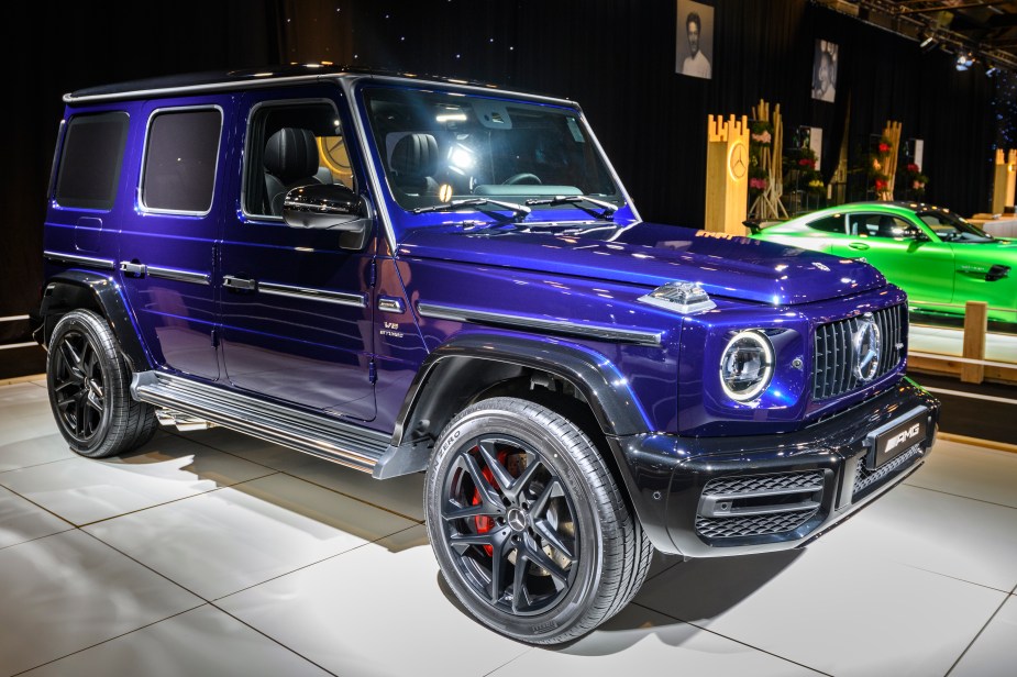 a Mercedes G-Class in purple at an auto show