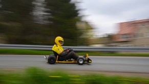 A go kart driving down the road.