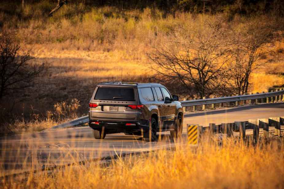 Gray 2023 Jeep Wagoneer driving on a country road, highlighting its release date and price