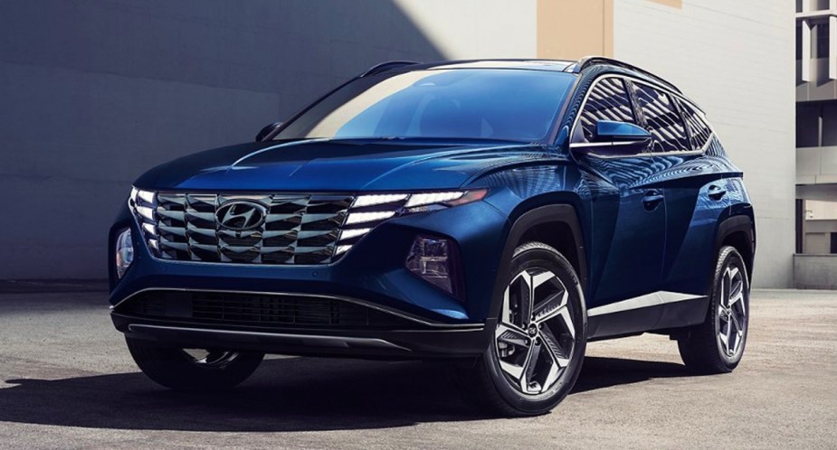 A blue 2022 Hyundai Tucson Hybrid SUV is parked. 