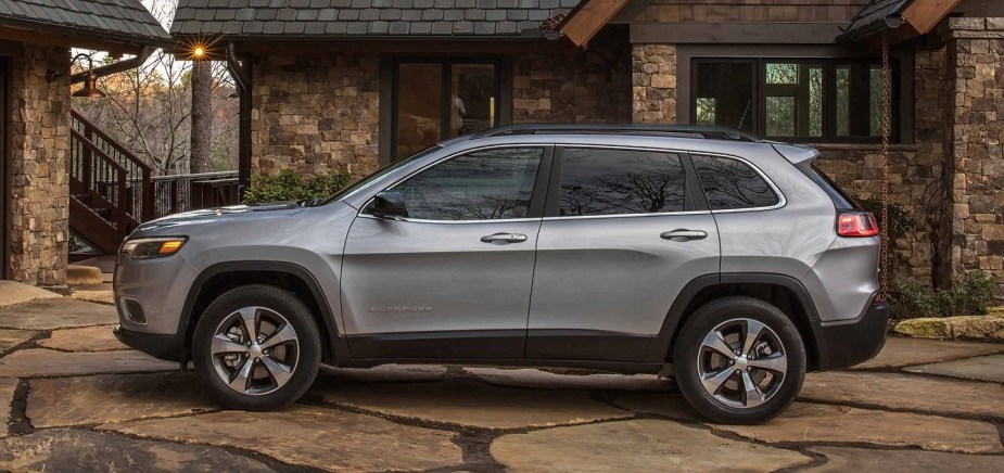 A silver 2022 Jeep Cherokee outside of a house.