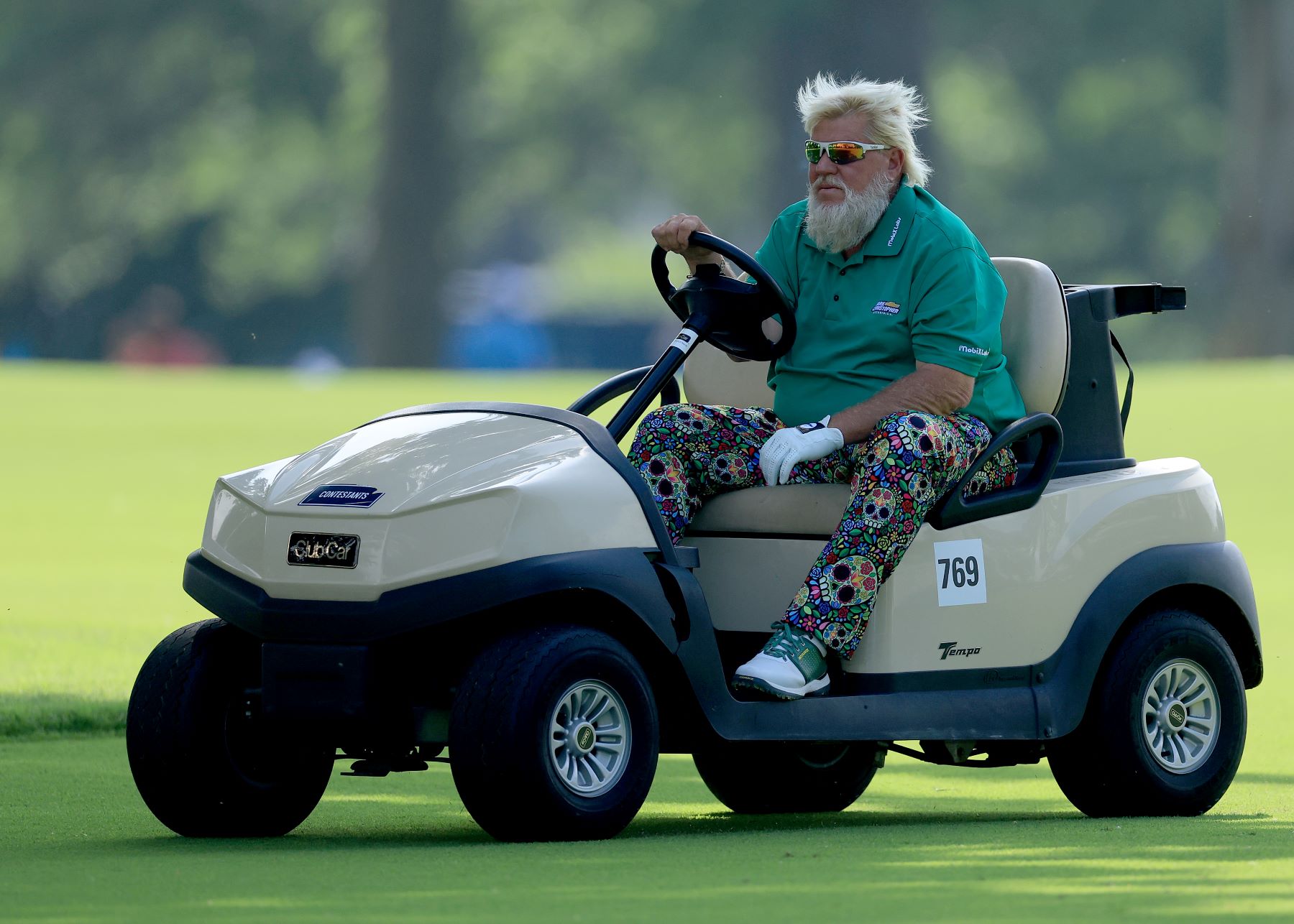 John Daly in a golf cart during the 2022 PGA Championship at the Southern Hills Country Club in Tulsa, Oklahoma