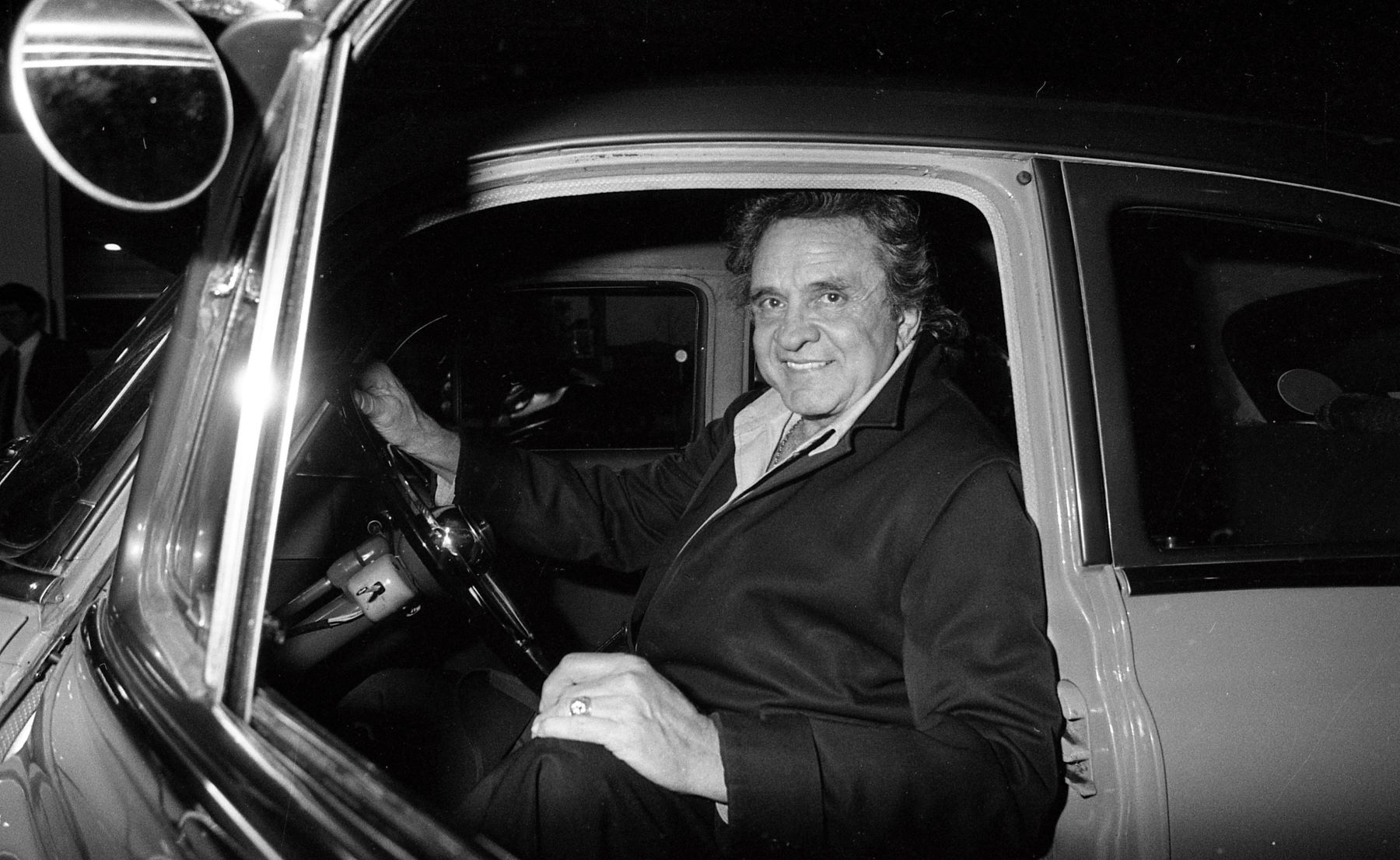 Johnny Cash driving in a 1950 Pontiac, seen at the Dublin Airpot in Ireland