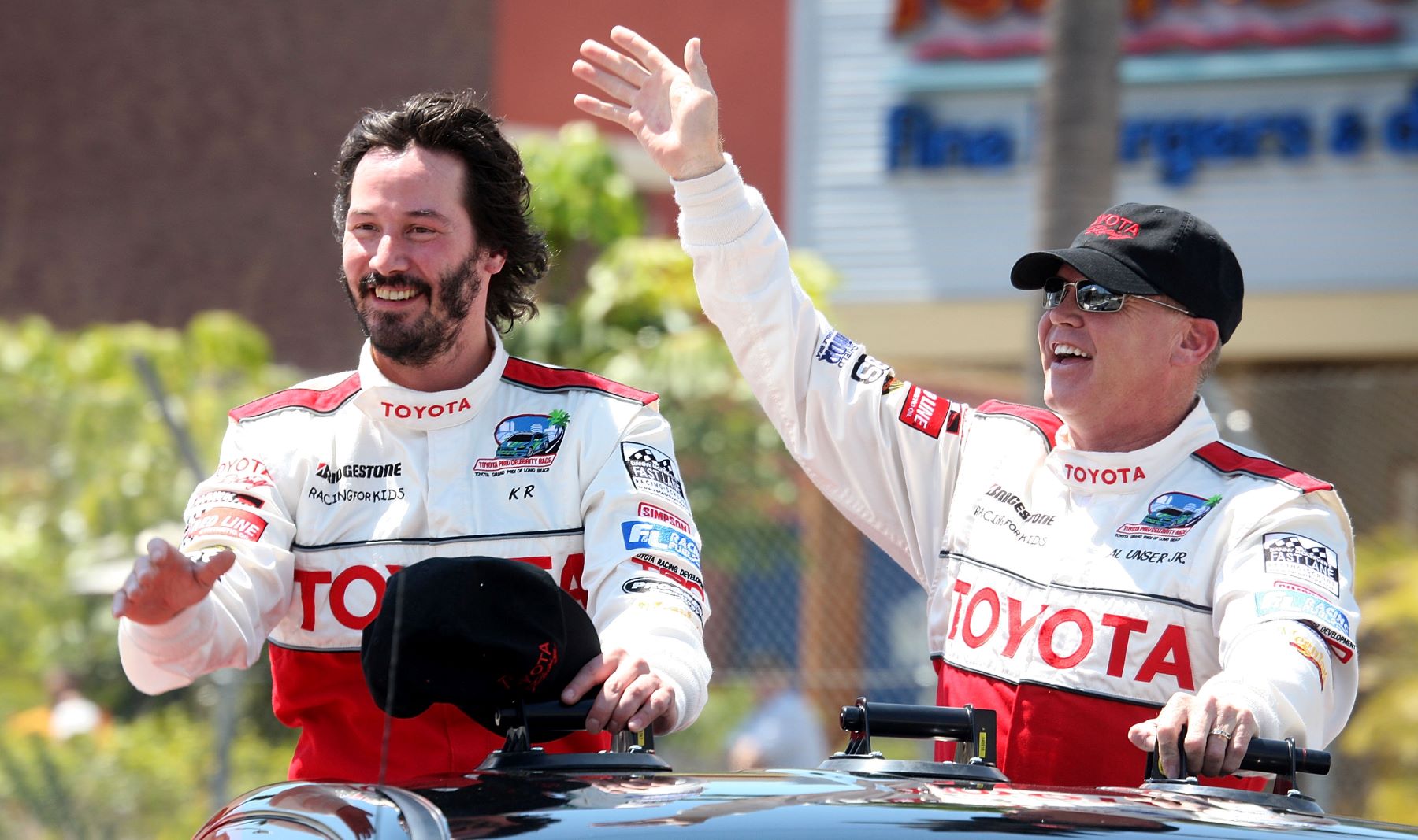 Keanu Reeves and race car driver Al Unser Jr. after winning a celebrity race at the Toyota Grand Prix
