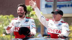 Keanu Reeves and race car driver Al Unser Jr. after winning a celebrity race at the Toyota Grand Prix