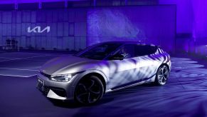 A silver Kia EV6 with a blue cast on it.