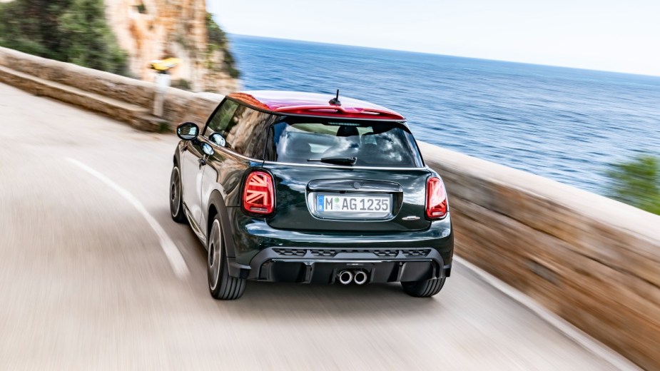 a mini jcw hardtop driving along the coast with refined performance