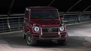 A burgundy 2022 Mercedes-Benz G-Class luxury SUV is parked.