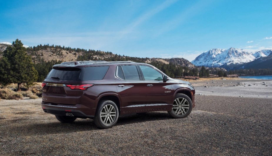 Rear angle view of maroon 2023 Chevy Traverse, highlighting its release date and price