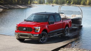 Red 2023 Ford F-150 towing a boat, highlighting its release date and price