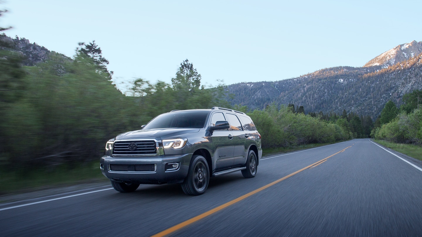 A gray 2022 Toyota Sequoia driving down a mountainous highway.