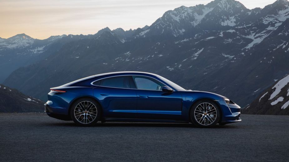Side view of the blue 2023 Porsche Taycan, highlighting its launch date and price