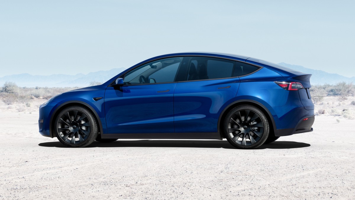 Side view of blue 2023 Tesla Model Y, highlighting its release date and price
