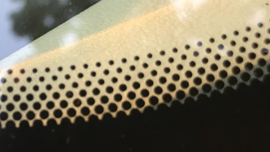 Small black dots, aka frits, on a car windshield