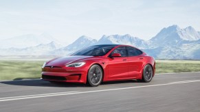 a red tesla model s, a fast ev with an impressive range to keep you on the road