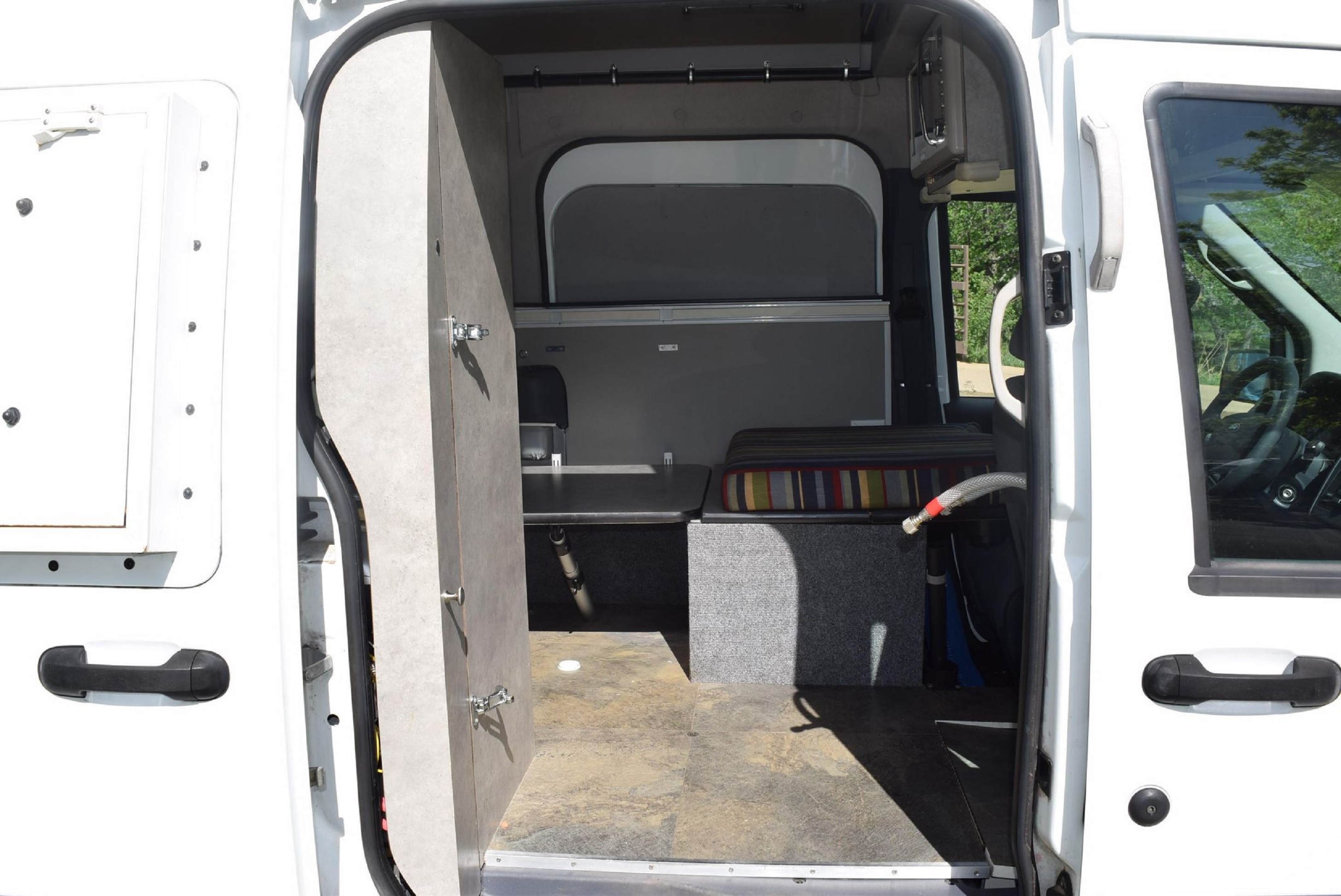 The interior of a white 2011 Ford Transit Connect XLT camper van