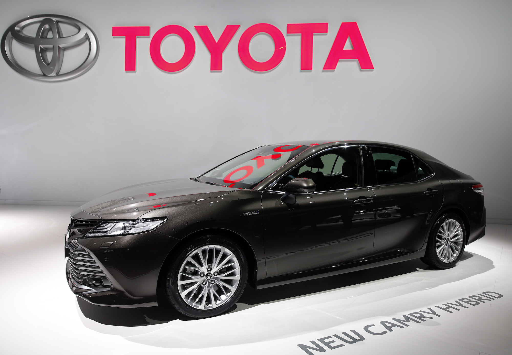 A black Toyota Camry Hybrid, which is one of the best Toyota cars for highway fuel economy.