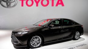 A black Toyota Camry Hybrid, which is one of the best Toyota cars for highway fuel economy.