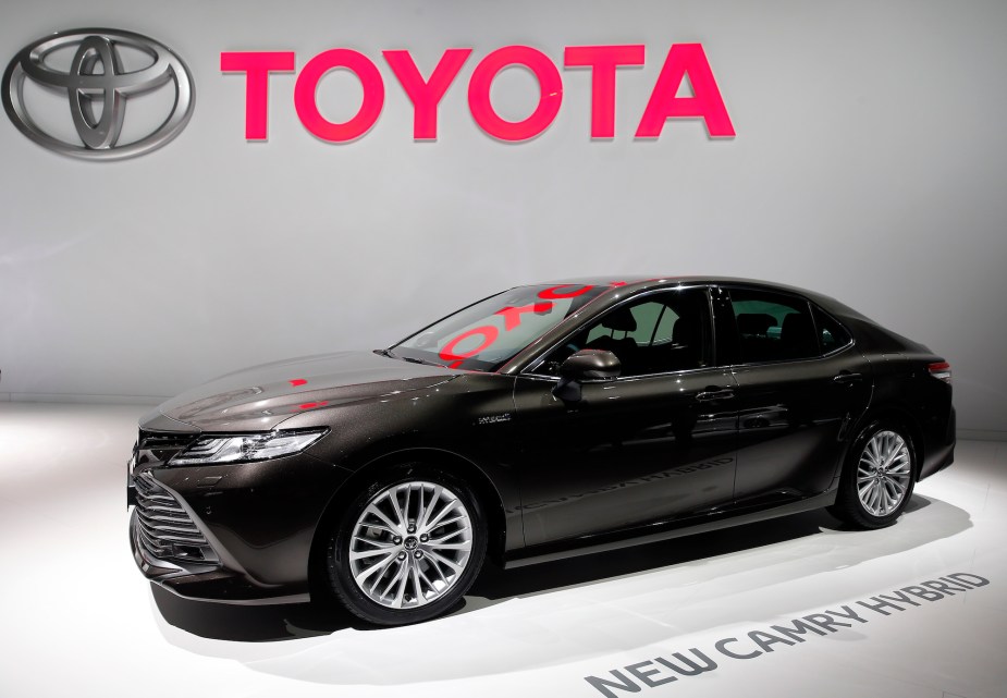 A black Toyota Camry Hybrid, one of the best Toyota cars for highway fuel economy.