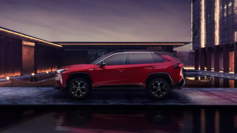 A red 2022 Toyota RAV4 Prime plug-in hybrid SUV is parked outdoors.
