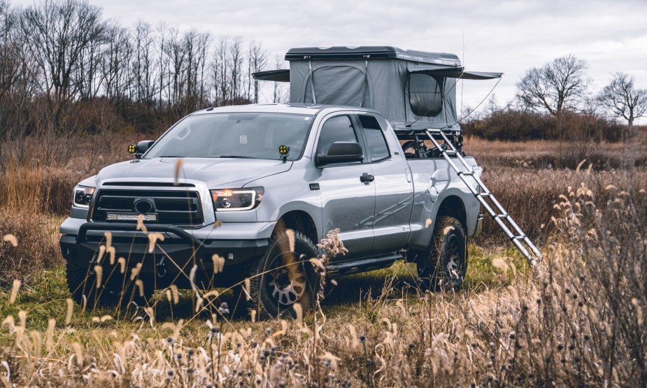This truck is configured for camping with a tent and ladder