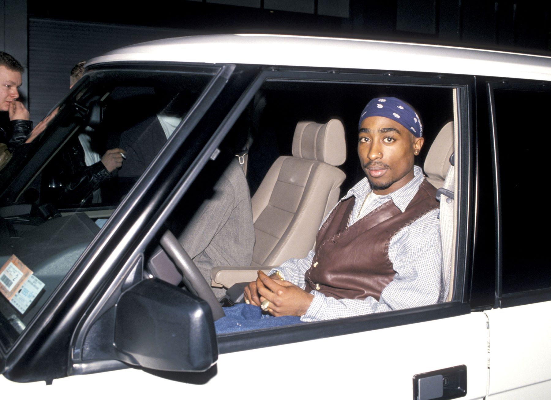 Tupac Shakur seated in a car during 'Red Rock West' at Club USA in New York City