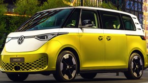 A white and yellow Volkswagen ID. Buzz electric microbus is parked.