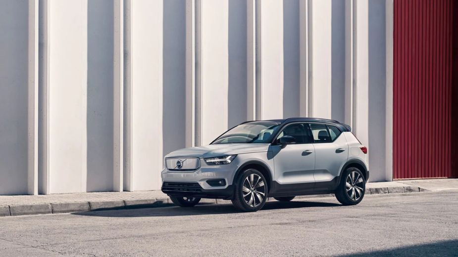 A silver 2022 Volvo XC40 Recharge is parked on a curb.