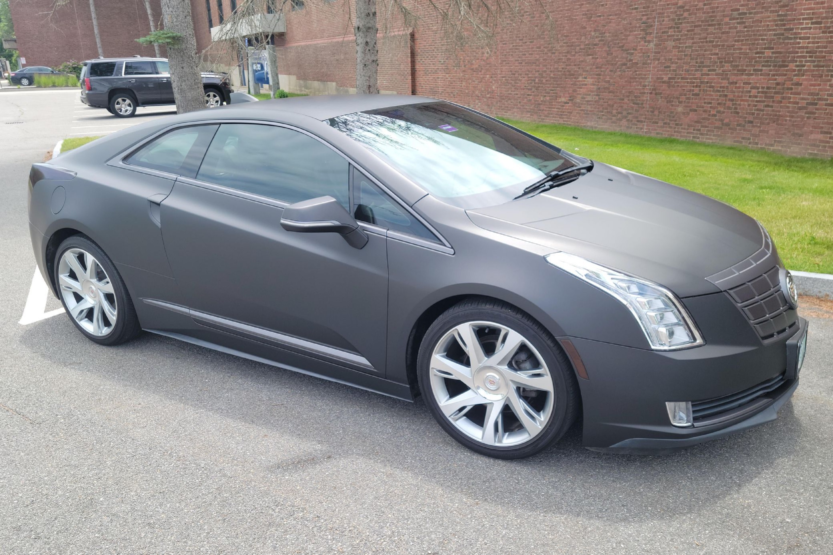 A 2014 Cadillac ELR wrapped in black in a parking lot