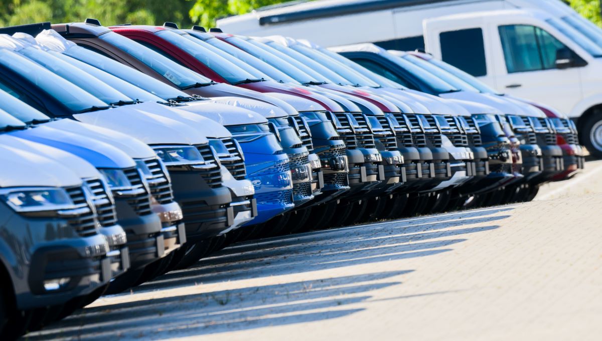 A row of new cars at a dealership