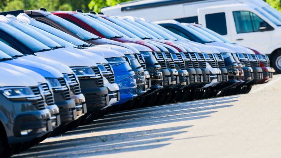 A row of new cars at a dealership