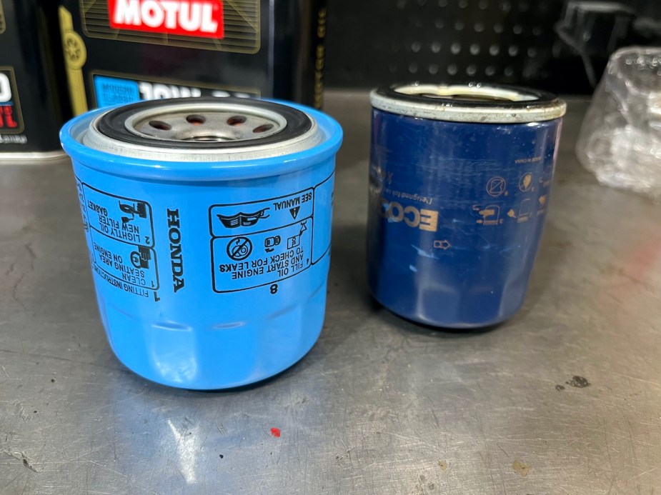 An OEM Honda oil filter sitting next to a generic one.