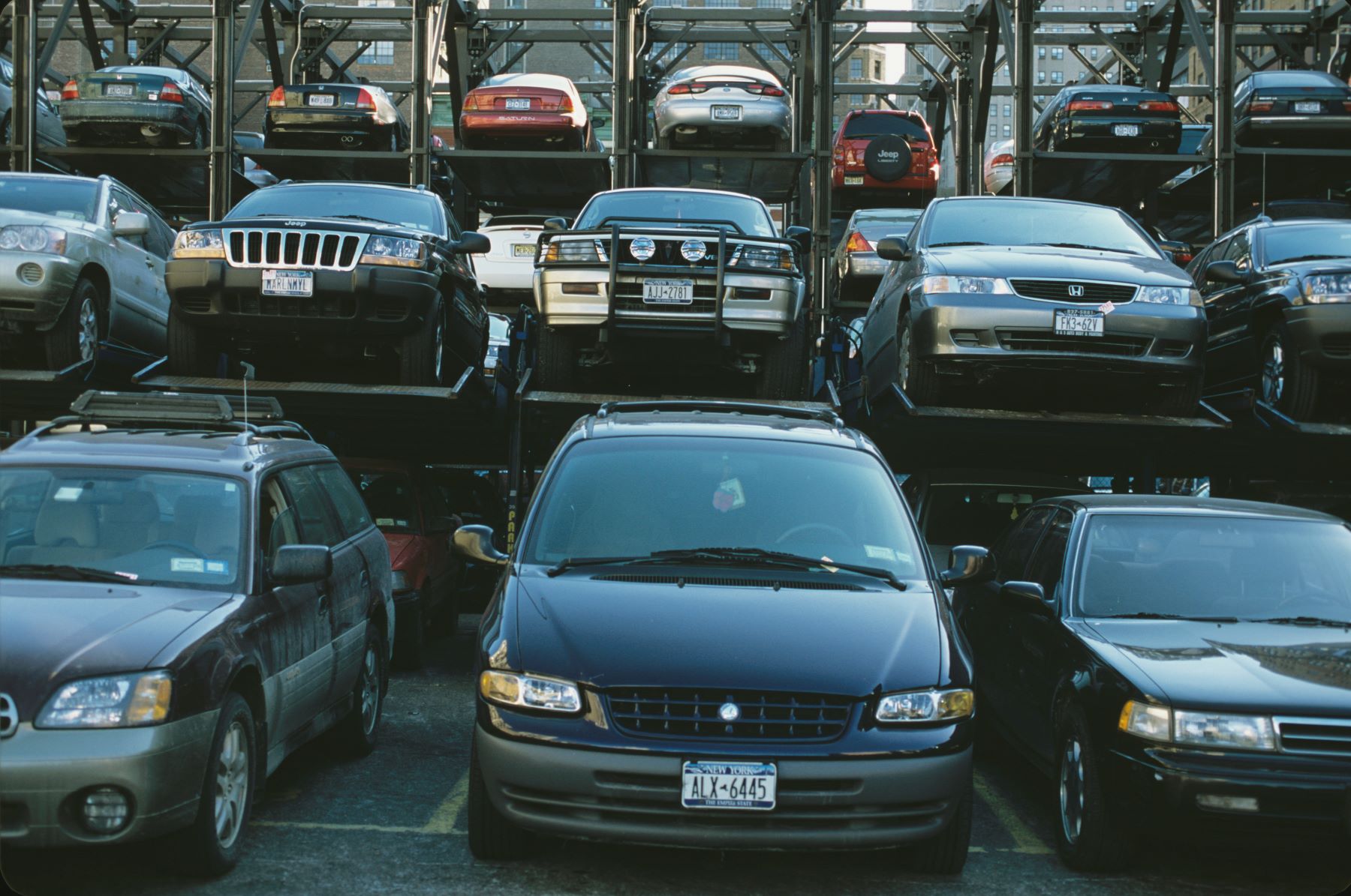 Minivans and SUVs in a Manhattan parking garage